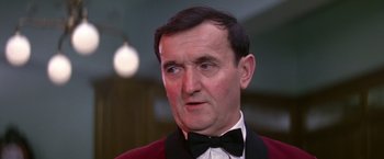 Movie still from “Victor/Victoria” (1982), directed by Blake Edwards – A person wearing a suit and bow tie; Close Up shot, Low angle