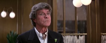 Movie still from “Victor/Victoria” (1982), directed by Blake Edwards – An older man in a suit and tie looking at the camera; Close Up shot, Low angle