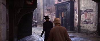 Movie still from “Victor/Victoria” (1982), directed by Blake Edwards – Two people walking down a street in a city; Wide shot, High angle