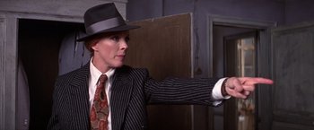 Movie still from “Victor/Victoria” (1982), directed by Blake Edwards – A man in a suit and hat pointing to the side; Medium shot, Low angle