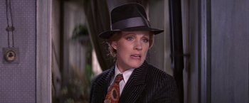Movie still from “Victor/Victoria” (1982), directed by Blake Edwards – A person wearing a suit and a hat; Close Up shot, Over the shoulder angle