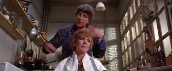 Movie still from “Victor/Victoria” (1982), directed by Blake Edwards – An older woman getting her hair cut by a barber; Medium shot, Over the shoulder angle
