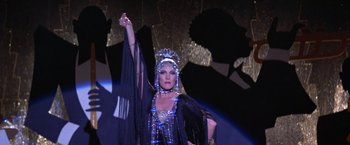 Movie still from “Victor/Victoria” (1982), directed by Blake Edwards – A woman in a black and blue dress on a stage; Medium shot, Low angle