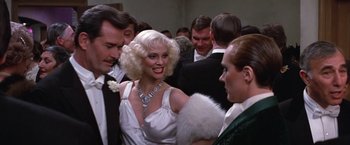 Movie still from “Victor/Victoria” (1982), directed by Blake Edwards – A woman in a white dress at a party; Close Up shot, Over the shoulder angle
