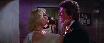 Movie still from “Victor/Victoria” (1982), directed by Blake Edwards – A man and a woman are dancing in a room; Close Up shot, Over the shoulder angle