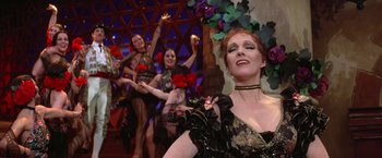 Movie still from “Victor/Victoria” (1982), directed by Blake Edwards – A group of women dressed up in costumes and holding candles; Medium shot, Low angle