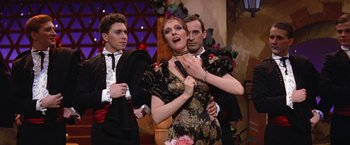 Movie still from “Victor/Victoria” (1982), directed by Blake Edwards – A group of people standing next to each other on a stage; Medium shot, Low angle