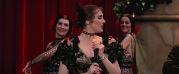 Movie still from “Victor/Victoria” (1982), directed by Blake Edwards – A group of women standing next to each other on a stage; Medium shot, Over the shoulder angle