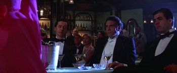 Movie still from “Victor/Victoria” (1982), directed by Blake Edwards – A group of people sitting at a table with wine glasses; Medium shot, Low angle