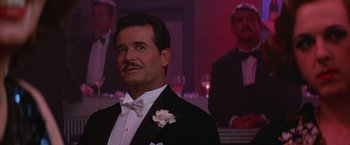 Movie still from “Victor/Victoria” (1982), directed by Blake Edwards – A man wearing a tuxedo and a white bow tie; Close Up shot, Low angle