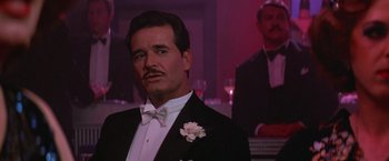 Movie still from “Victor/Victoria” (1982), directed by Blake Edwards – A man in a tuxedo with a white flower in his lapel; Close Up shot, Low angle