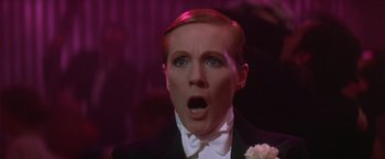 Movie still from “Victor/Victoria” (1982), directed by Blake Edwards – A man in a tuxedo with a surprised look on his face; Close Up shot, Low angle