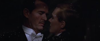 Movie still from “Victor/Victoria” (1982), directed by Blake Edwards – A man and a woman in the dark looking into each others eyes; Close Up shot, Overhead angle