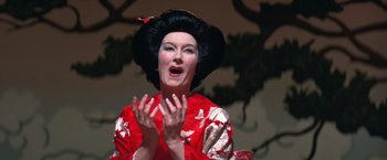 Movie still from “Victor/Victoria” (1982), directed by Blake Edwards – A woman wearing a red kimono and a black wig; Close Up shot, Low angle