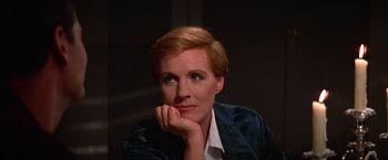Movie still from “Victor/Victoria” (1982), directed by Blake Edwards – A woman with short blonde hair sitting in front of a wall; Close Up shot, High angle