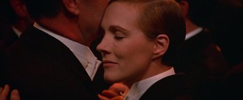 Movie still from “Victor/Victoria” (1982), directed by Blake Edwards – A person wearing a suit and tie; Close Up shot, Over the shoulder angle