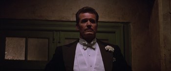 Movie still from “Victor/Victoria” (1982), directed by Blake Edwards – A man wearing a tuxedo and a white bow tie; Close Up shot, Low angle
