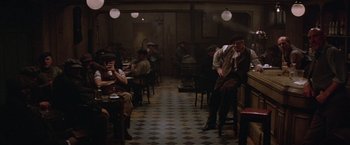 Movie still from “Victor/Victoria” (1982), directed by Blake Edwards – A group of people sitting at tables in a restaurant; Wide shot, High angle