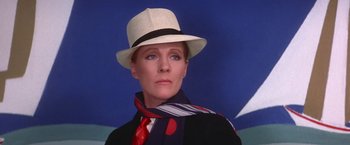 Movie still from “Victor/Victoria” (1982), directed by Blake Edwards – A woman wearing a white hat and a scarf; Close Up shot, Low angle