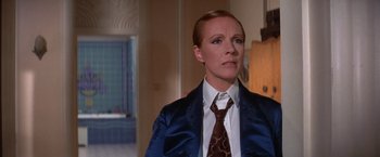 Movie still from “Victor/Victoria” (1982), directed by Blake Edwards – A woman wearing a suit and tie in front of a mirror; Close Up shot, Over the shoulder angle