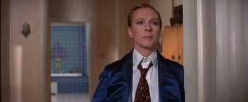 Movie still from “Victor/Victoria” (1982), directed by Blake Edwards – A person wearing a suit and tie in a room; Close Up shot, Low angle