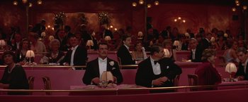 Movie still from “Victor/Victoria” (1982), directed by Blake Edwards – A group of people sitting at a table in formal wear; Wide shot, High angle