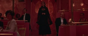 Movie still from “Victor/Victoria” (1982), directed by Blake Edwards – A woman in a black dress standing in front of two men; Wide shot, Low angle