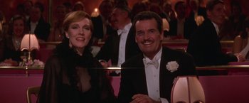Movie still from “Victor/Victoria” (1982), directed by Blake Edwards – A man and a woman are smiling for the camera; Medium shot, High angle