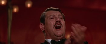 Movie still from “Victor/Victoria” (1982), directed by Blake Edwards – A person wearing a suit and tie; Close Up shot, Low angle