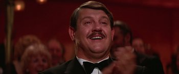 Movie still from “Victor/Victoria” (1982), directed by Blake Edwards – A person wearing a suit and tie; Close Up shot, Low angle