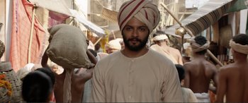 Movie still from “Victoria & Abdul” (2017), directed by Stephen Frears – A man with a turban is standing in a crowd; Medium shot, Low angle