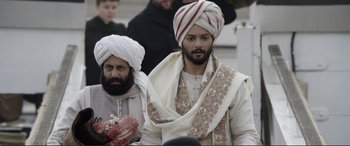 Movie still from “Victoria & Abdul” (2017), directed by Stephen Frears – A man in a turban is standing next to another man in a turban; Medium shot, Over the shoulder angle