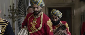 Movie still from “Victoria & Abdul” (2017), directed by Stephen Frears – A man in a turban is standing next to another man in a turban; Medium shot, Low angle