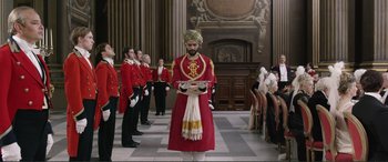 Movie still from “Victoria & Abdul” (2017), directed by Stephen Frears – A group of men standing in front of a crowd; Wide shot, Low angle