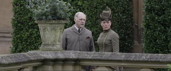 Movie still from “Victoria & Abdul” (2017), directed by Stephen Frears – A man and a woman standing next to each other; Medium shot, Low angle