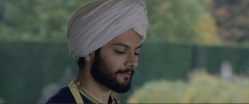 Movie still from “Victoria & Abdul” (2017), directed by Stephen Frears – A man with a beard wearing a turban; Close Up shot, Low angle