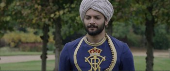 Movie still from “Victoria & Abdul” (2017), directed by Stephen Frears – A man wearing a turban and a blue outfit; Close Up shot, Over the shoulder angle