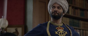 Movie still from “Victoria & Abdul” (2017), directed by Stephen Frears – A man with a beard and a turban is wearing a turban; Close Up shot, Over the shoulder angle