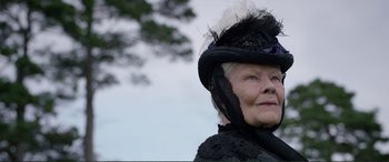 Movie still from “Victoria & Abdul” (2017), directed by Stephen Frears – An older woman wearing a black hat and a black dress; Close Up shot, Low angle