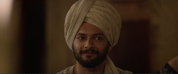 Movie still from “Victoria & Abdul” (2017), directed by Stephen Frears – A man with a turban on his head and a beard; Close Up shot, Over the shoulder angle