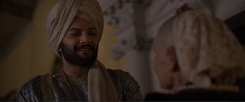 Movie still from “Victoria & Abdul” (2017), directed by Stephen Frears – A man with a turban is talking to another man; Close Up shot, Over the shoulder angle