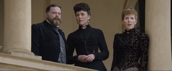 Movie still from “Victoria & Abdul” (2017), directed by Stephen Frears – A man and a woman standing next to each other on steps; Medium shot, Low angle