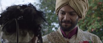 Movie still from “Victoria & Abdul” (2017), directed by Stephen Frears – A man wearing a turban and a gold outfit; Close Up shot, Over the shoulder angle