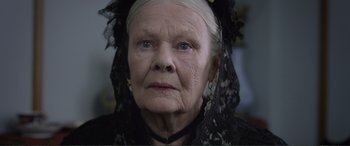 Movie still from “Victoria & Abdul” (2017), directed by Stephen Frears – An older woman wearing a black dress and a black veil; Close Up shot, Over the shoulder angle