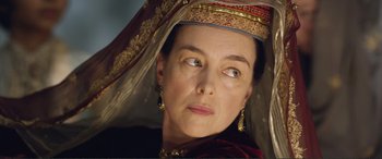 Movie still from “Victoria & Abdul” (2017), directed by Stephen Frears – An older woman wearing a headdress and earrings; Close Up shot, Over the shoulder angle