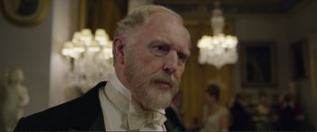 Movie still from “Victoria & Abdul” (2017), directed by Stephen Frears – An old man with a beard wearing a white bow tie; Close Up shot, Over the shoulder angle