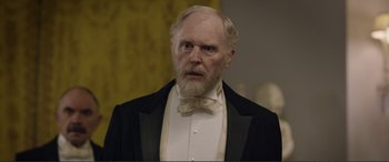 Movie still from “Victoria & Abdul” (2017), directed by Stephen Frears – An old man with a beard wearing a tuxedo; Close Up shot, Over the shoulder angle