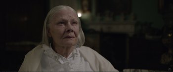 Movie still from “Victoria & Abdul” (2017), directed by Stephen Frears – An old woman with white hair and a white shirt; Close Up shot, Over the shoulder angle