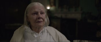 Movie still from “Victoria & Abdul” (2017), directed by Stephen Frears – An old woman with white hair looking at the camera; Close Up shot, Over the shoulder angle