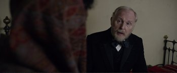 Movie still from “Victoria & Abdul” (2017), directed by Stephen Frears – An older man in a tuxedo looking at himself in the mirror; Close Up shot, Over the shoulder angle